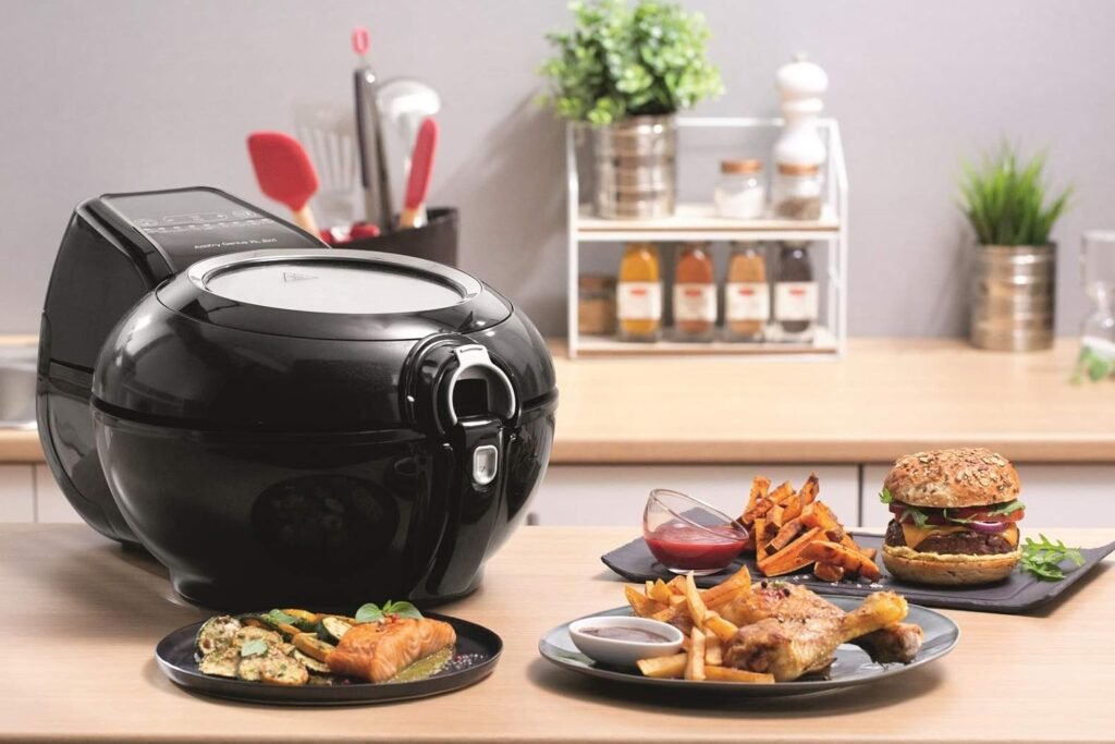 Tefal YV9708 ActiFry Genius XL 2-in-1 Heißluftfritteuse mit Rührarm, Testsieger, 1,7 kg für 8 Personen, 9 Automatikmenüs, 2 Mahlzeiten gleichzeitig, gesunde ölfreie Fritteuse, schwarz - Top Produktbild.